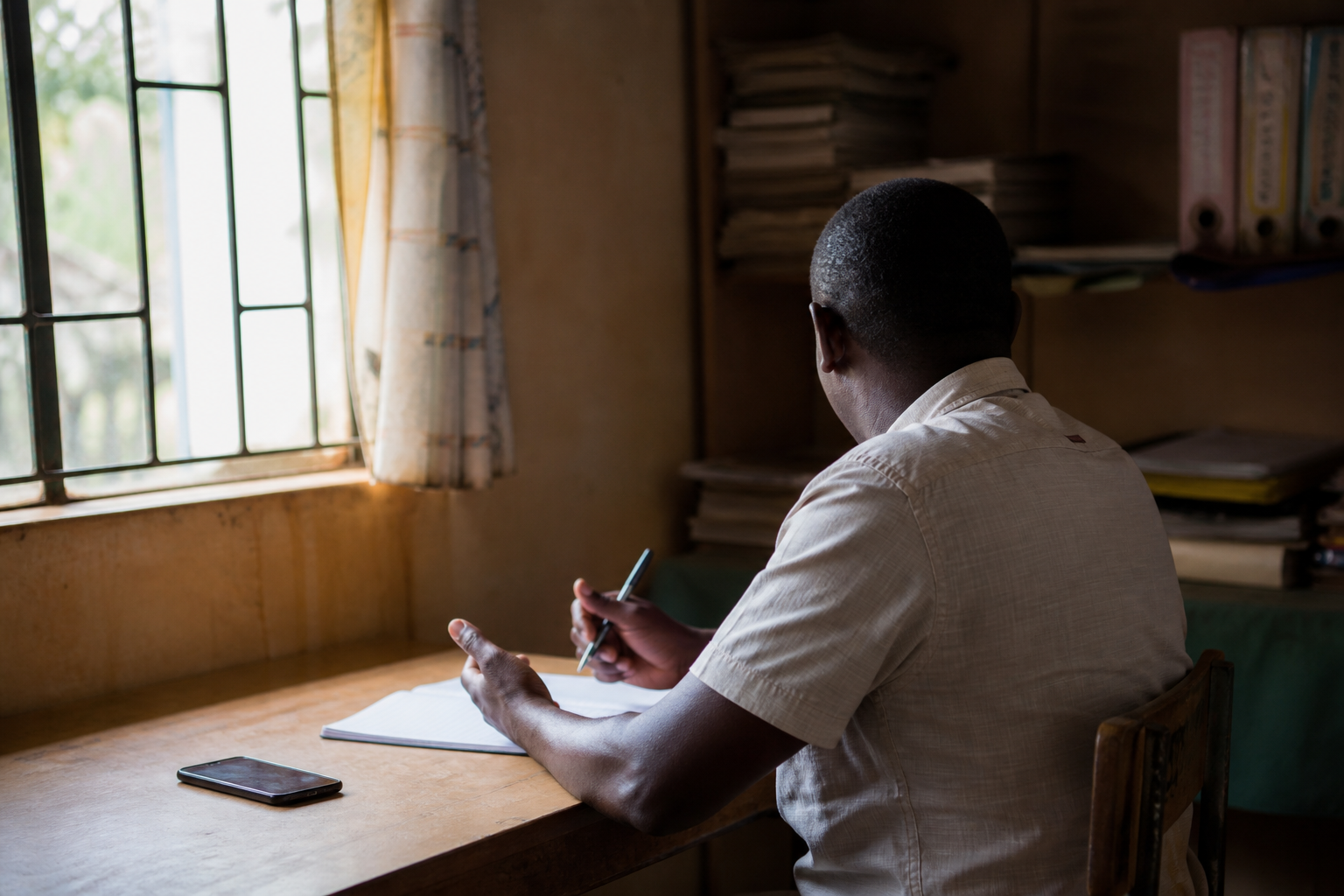Quiet desk with phone and notebook suggesting confidential family guidance